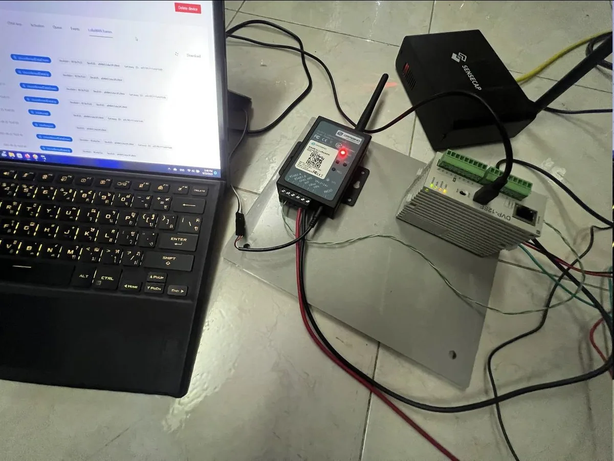 Southern IoT test bench with a Delta PLC, Dragino RS485 adapter, SenseCAP gateway, and a laptop showing ChirpStack.